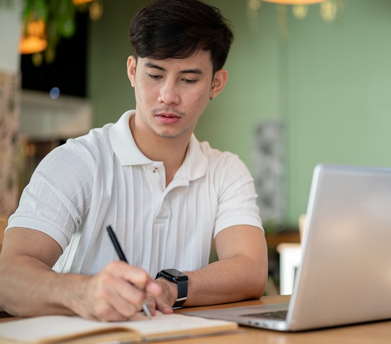 Guy in white shirt taking notes